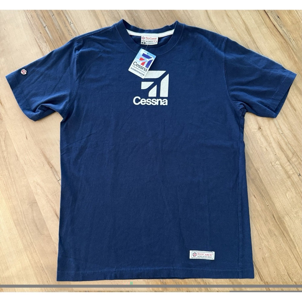 Red Canoe Cessna Logo T-Shirt Navy Blue Size Medium 100% Cotton Multi Flag Patch